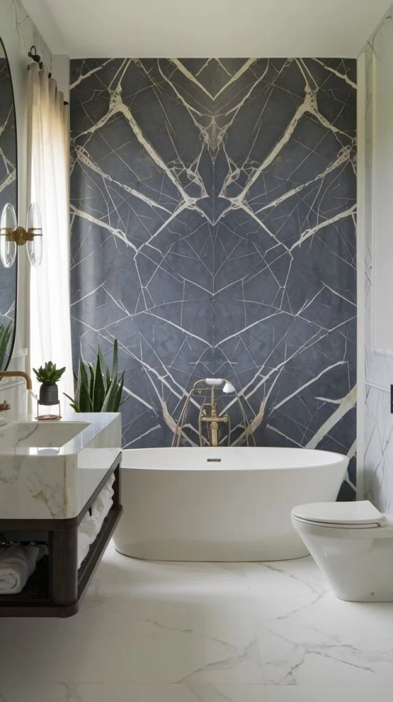Striking modern luxury accent wall with a dark blue/charcoal background and symmetrical, radiating white and gold hairline veining, contrasting with a clean white tub.