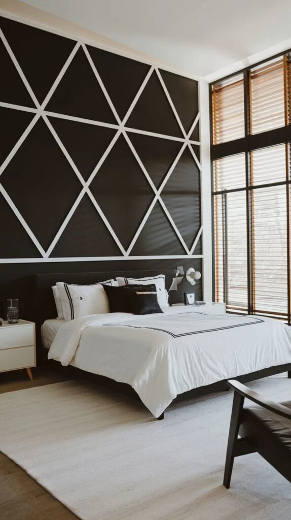 Black accent wall with bold white diamond geometric pattern behind the headboard