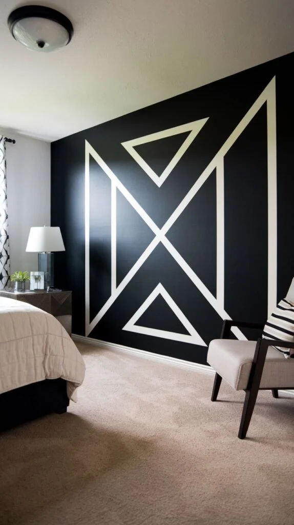 Black accent wall with large central geometric motif in thick white molding