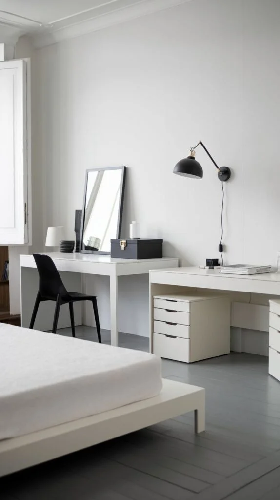 Minimalist bedroom with white desk, black chair, and simple bed frame