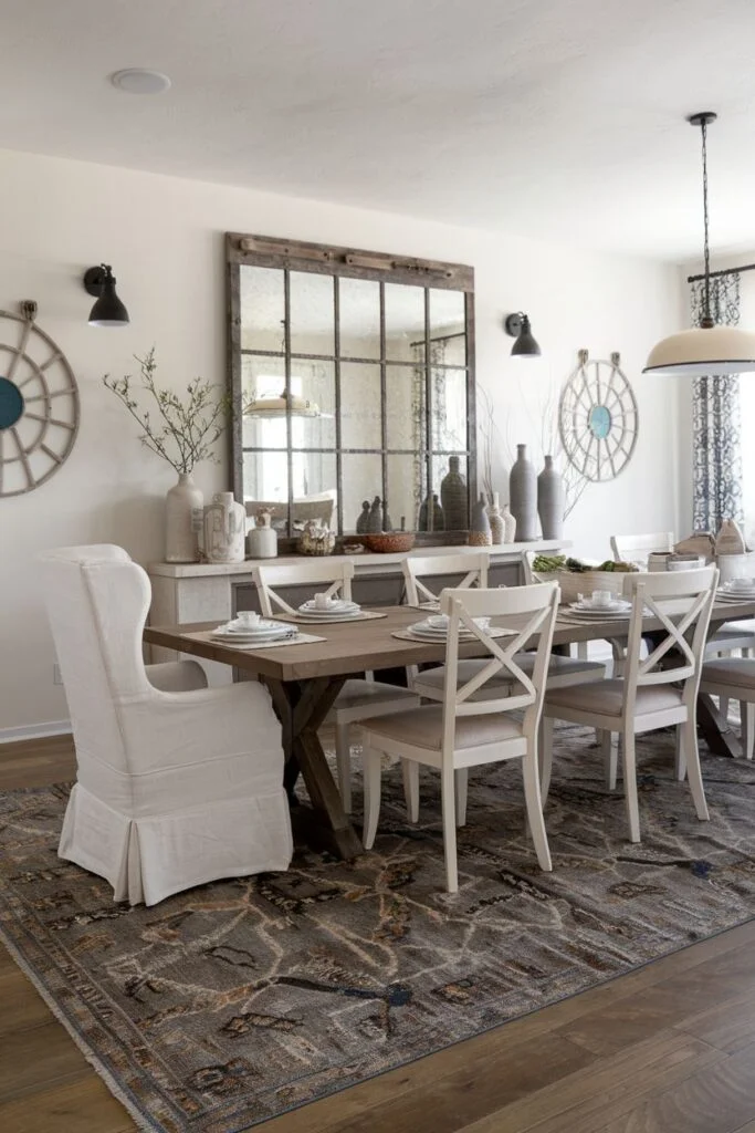 Textured farmhouse dining room with upholstered chairs and large mirror