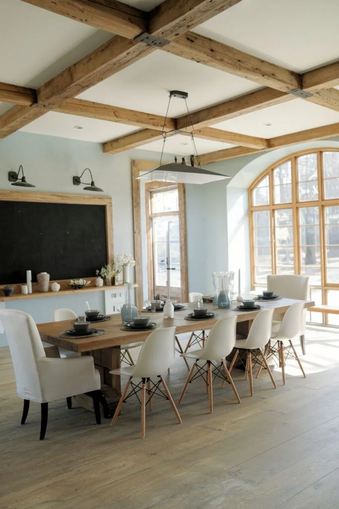 Large farmhouse dining room with mixed chairs and chalkboard wall