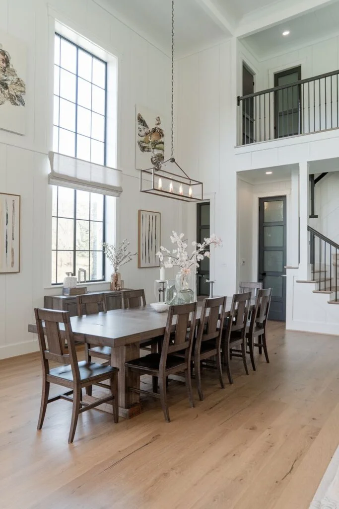 Tall farmhouse dining room with dark wood table and large chandelier