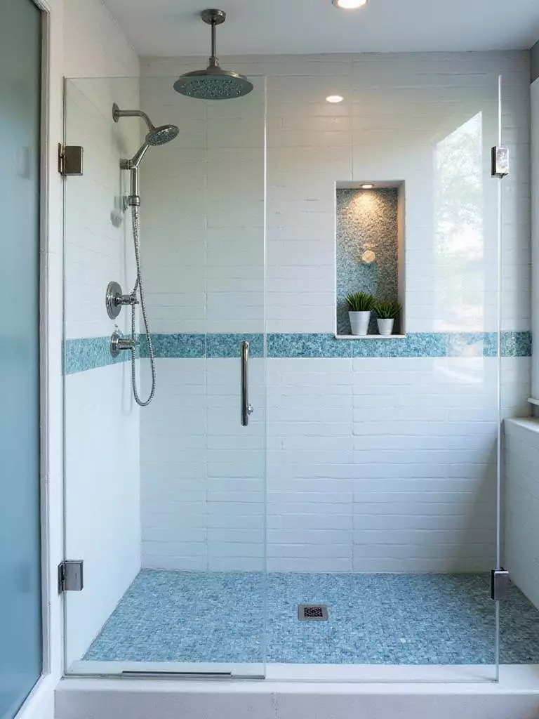 Custom tile shower with white subway tile and iridescent blue mosaic accent strip.