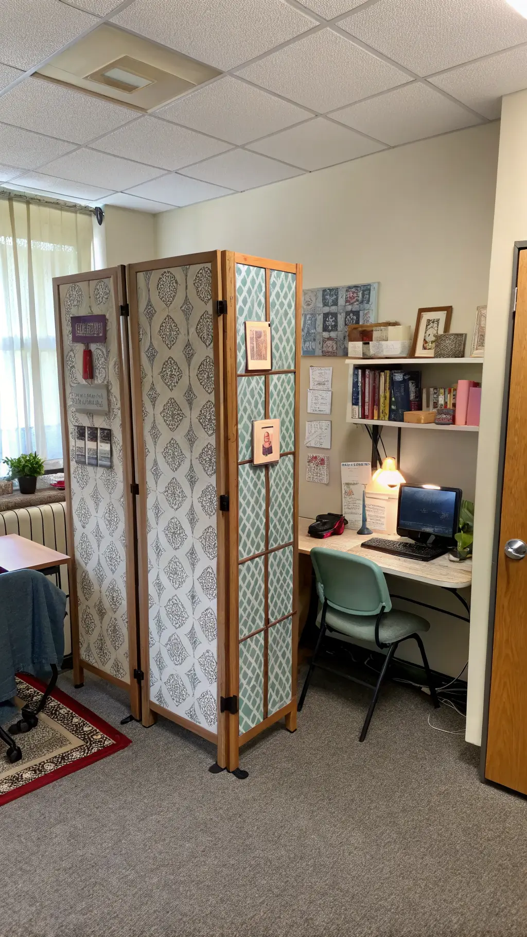 Shared dorm room with separate study areas divided by decorative screen, personalized desks and storage.