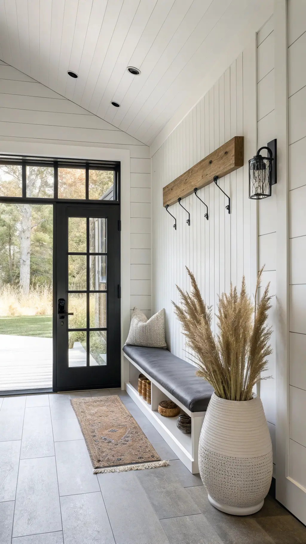 Bright entryway with white shiplap walls and Scandinavian decor