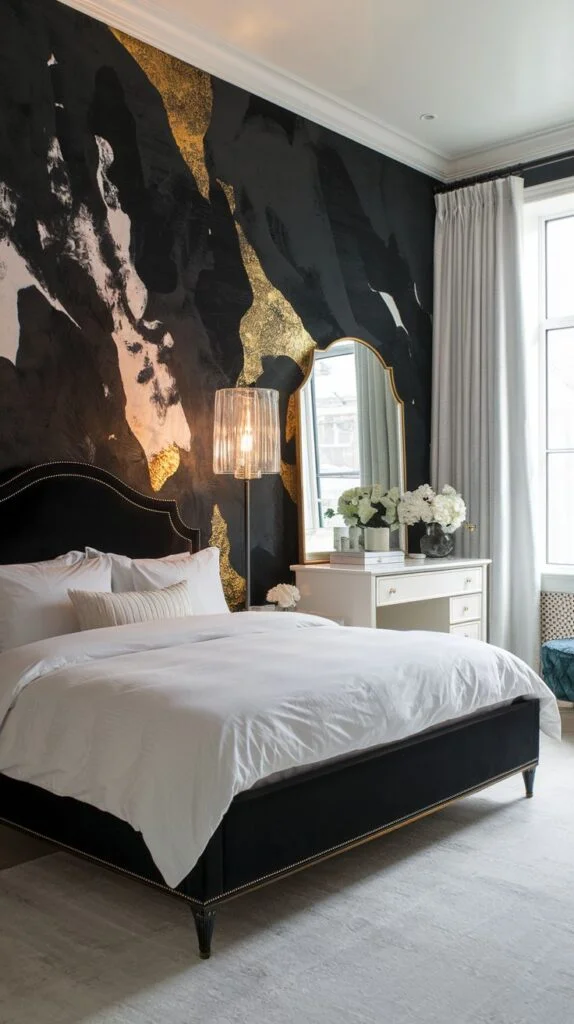 Bedroom with black accent wall featuring abstract gold and black marble swirl wallpaper behind a velvet bed