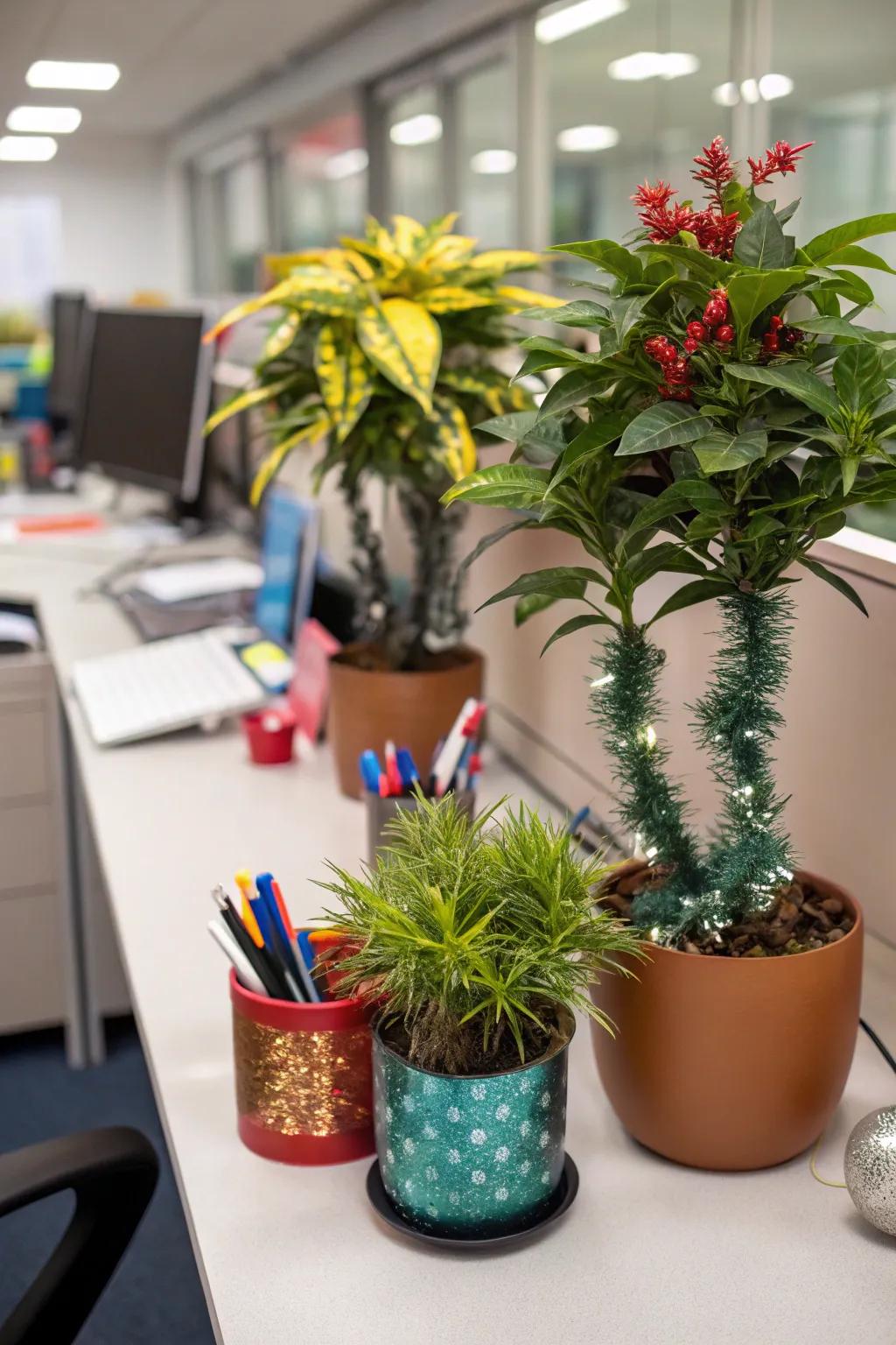 Desk plants decorated with mini ornaments and tinsel for Christmas.
