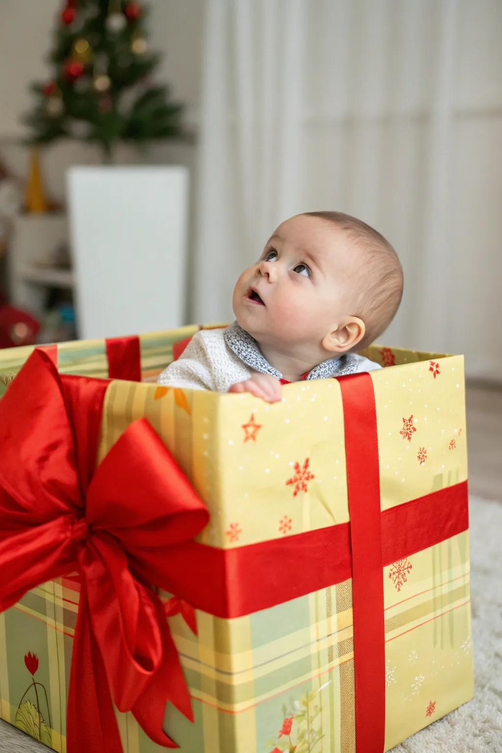 Baby peeking out of a large gift box, the ultimate holiday surprise.