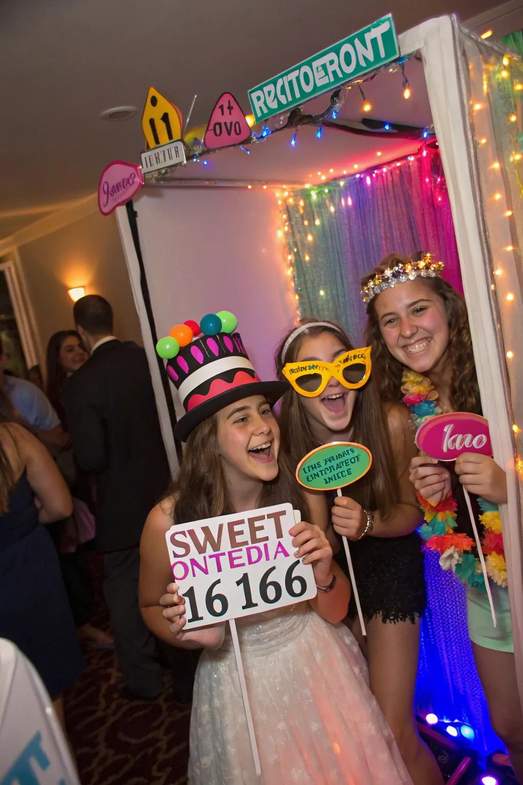 Guests enjoying a DIY photo booth at a sweet sixteen.
