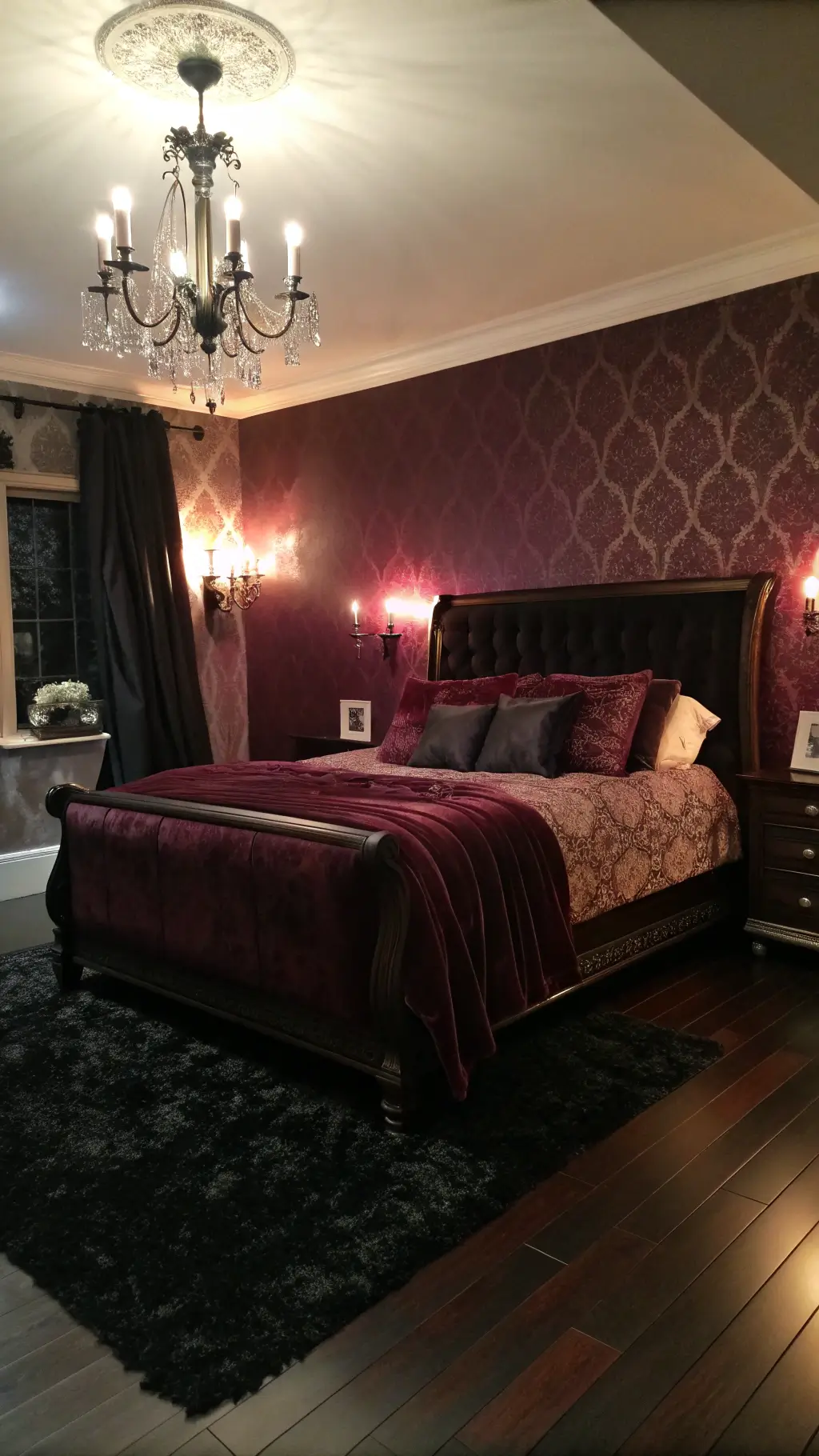 Dramatic candlelit bedroom with deep bordeaux walls, dark mahogany sleigh bed, rich fabrics, vintage crystal sconces casting shadows, and black sheepskin rug on hardwood floors.