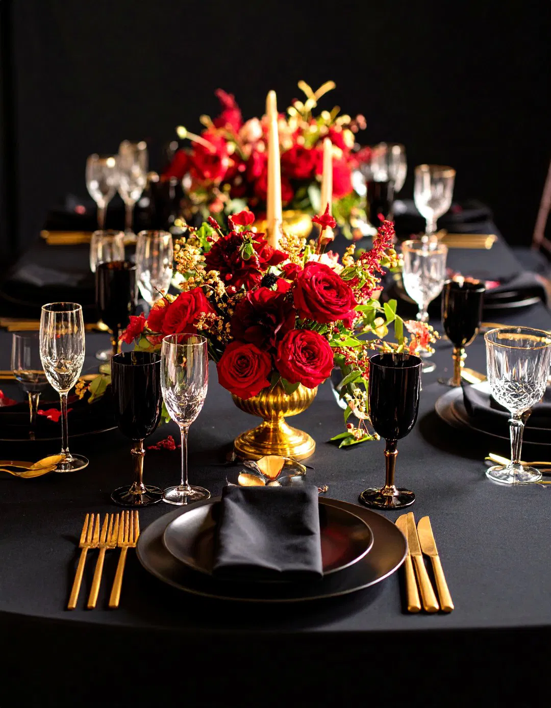 Black and Gold Wedding Table Settings with Red Flowers