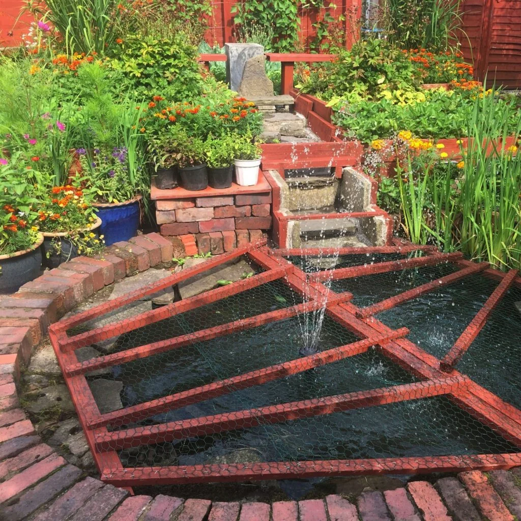 Community garden with multi-tiered pond and container plants