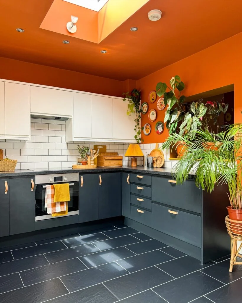 Bright orange painted kitchen ceiling