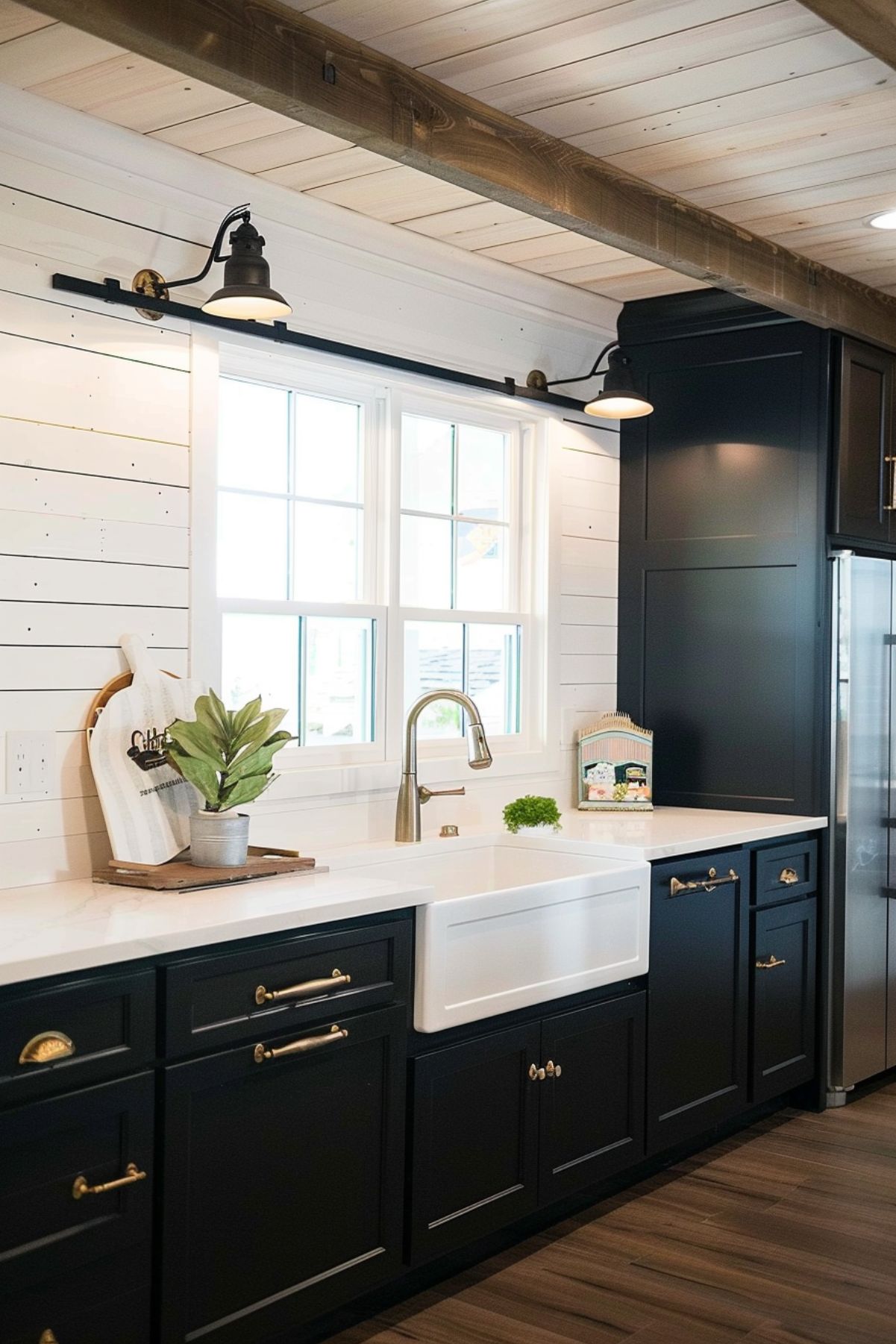 Kitchen with black cabinetry and a white sink.